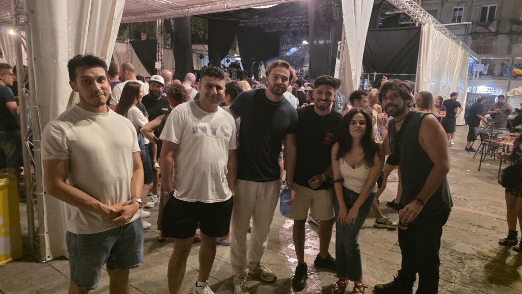 International friends at Las Fiestas de Gràcia 2025 in Barcelona, enjoying live music and concerts at Plaça del Sol.