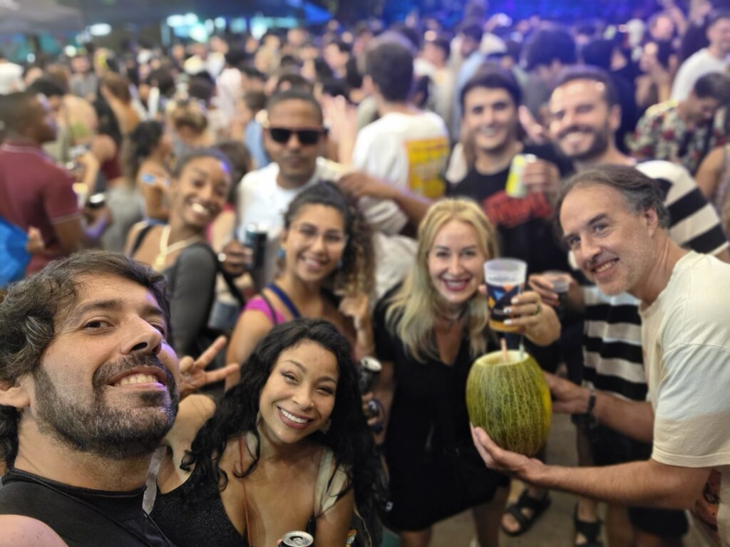 International group celebrating the last night of Las Fiestas de Gràcia 2025 in Barcelona, enjoying music, drinks, and festive atmosphere.