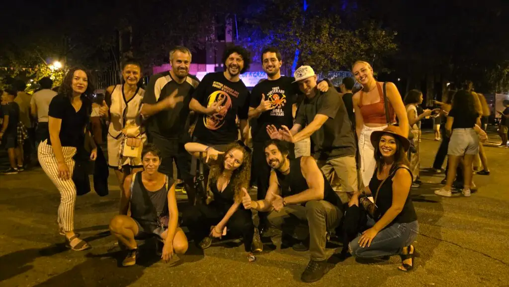 International friends celebrating the first night of the Poblenou Festival 2025 in Barcelona, enjoying music, dancing, and a vibrant street party atmosphere.