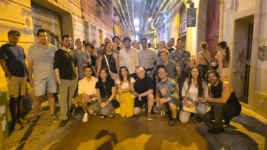 International group celebrating the fifth day of the Poblenou Festival 2025 in Barcelona, with street parties, music, and dancing.
