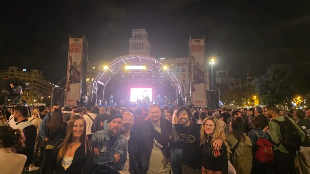 International friends at the first night of La Mercè Festival 2025 in Barcelona, enjoying a live concert at Plaça de Catalunya with music and celebrations.