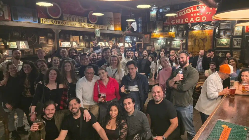 Group of international people enjoying the Saturday Language Exchange event in Barcelona at a lively pub, sharing drinks, conversations, and smiles in a warm multicultural atmosphere.