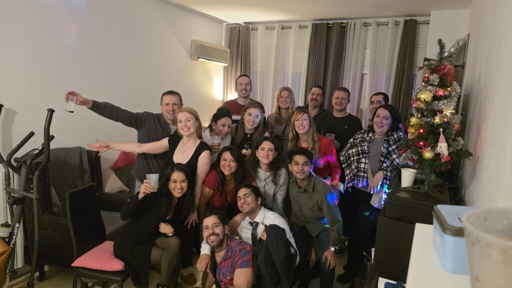 International group celebrating Christmas together in an apartment in Barcelona