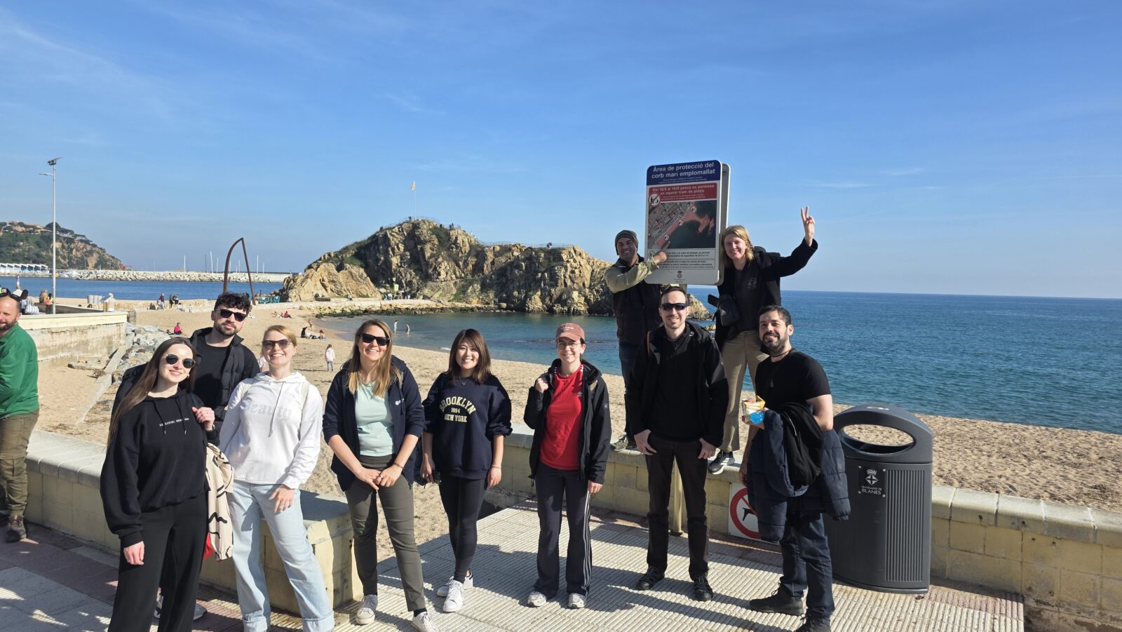 International meetup picnic at Blanes Beach Costa Brava near Barcelona with expats and travelers enjoying the Mediterranean coast