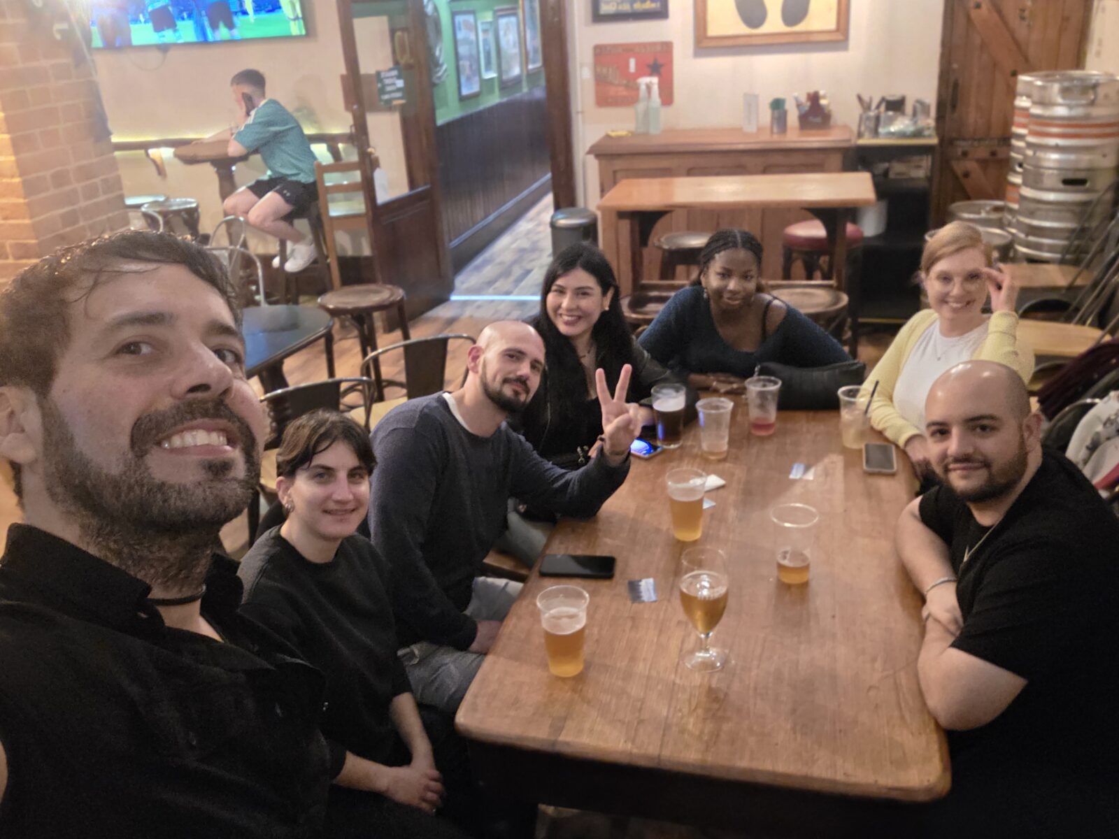 Group of friends enjoying drinks together at an Irish pub on St. Patrick’s Day 2026