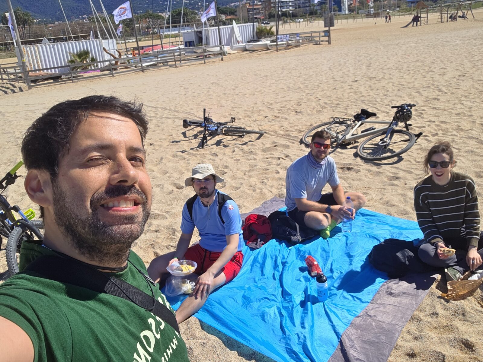 Cycling group from Barcelona to Premia de Mar enjoying a beach picnic during a New in Barcelona bike ride