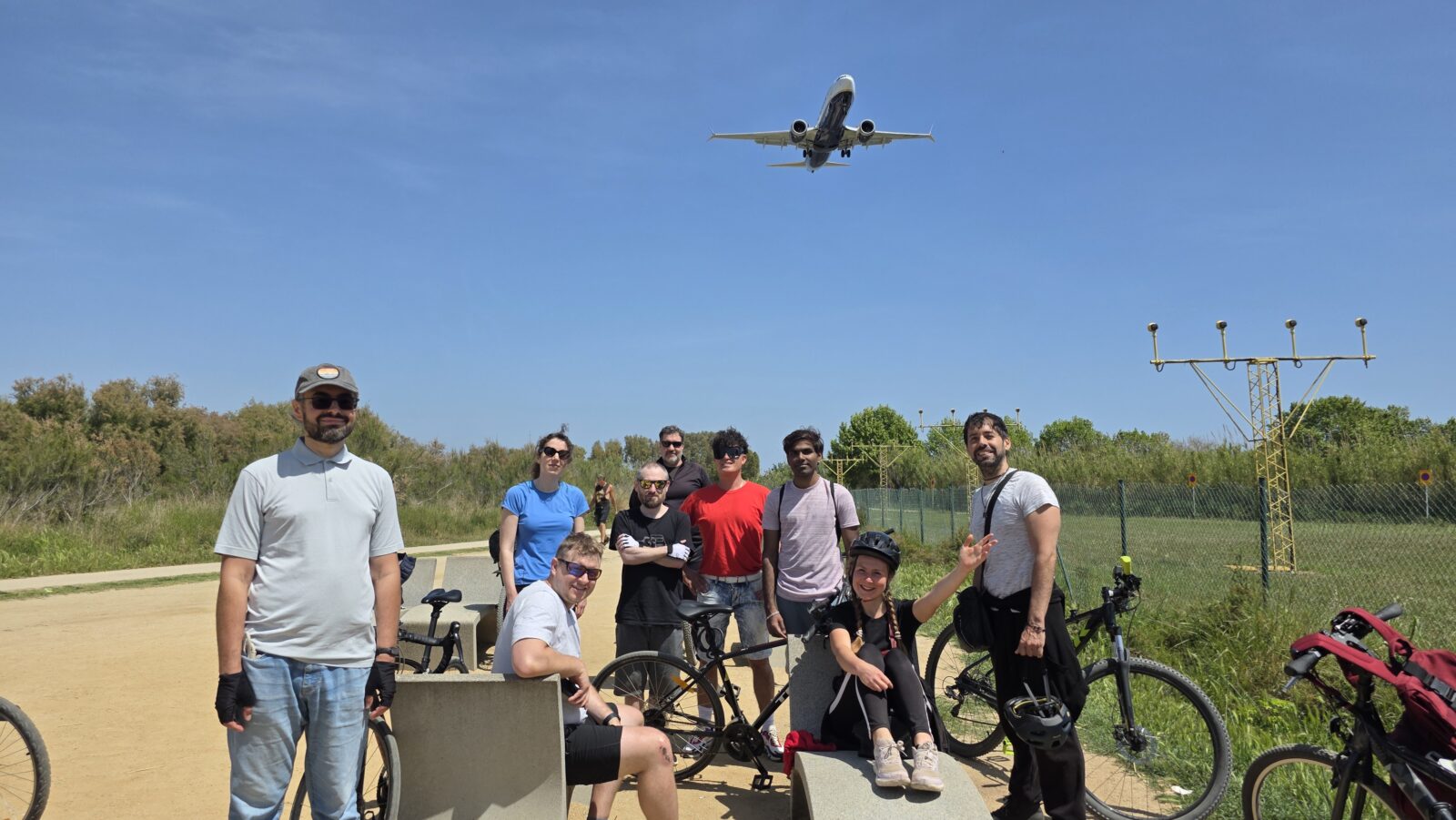 International cycling group in El Prat near Barcelona Airport watching airplanes during a New in Barcelona bike ride